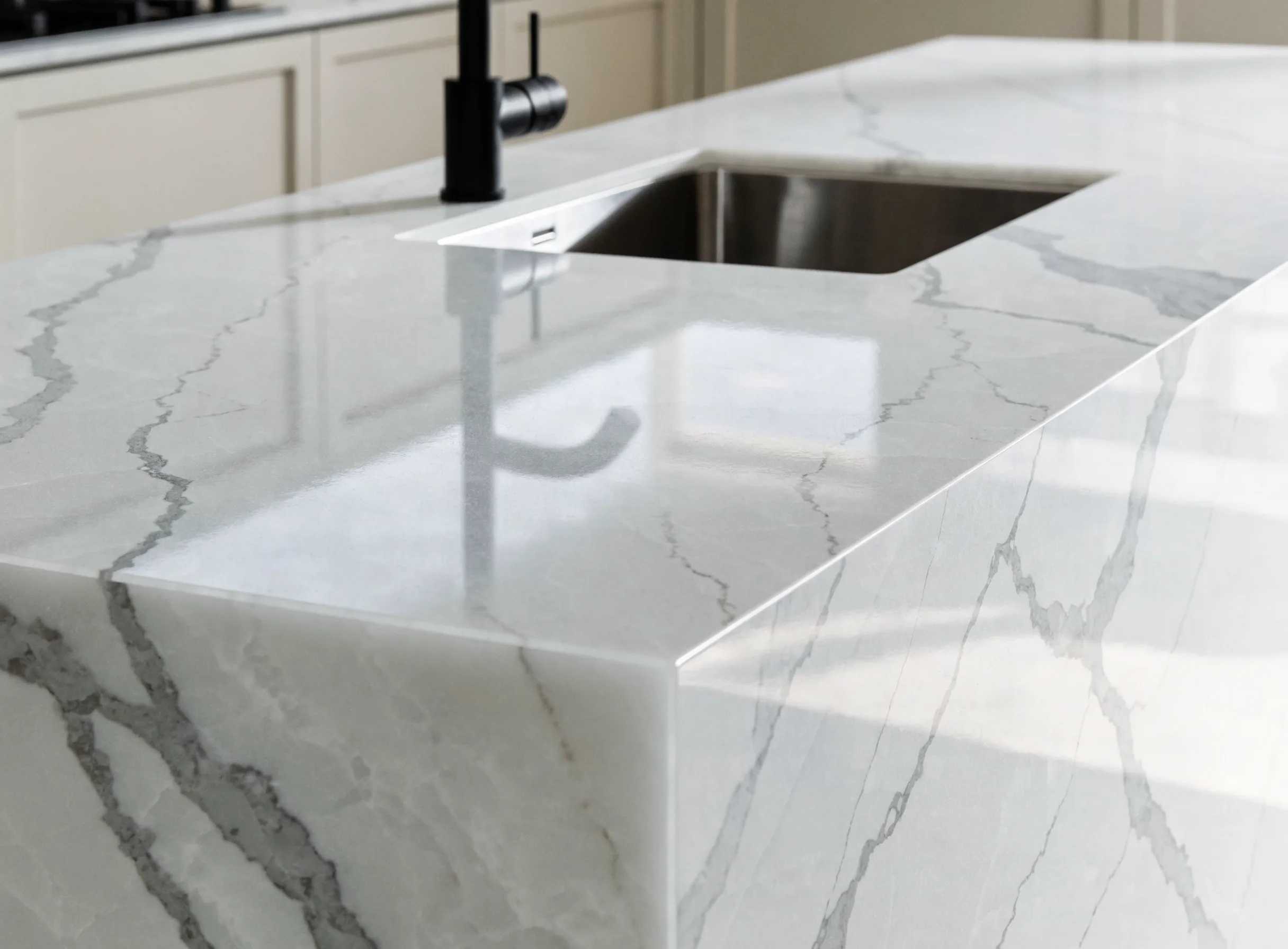A quartz countertop run with a waterfall end panel on the island, set during a Boca Raton kitchen remodel