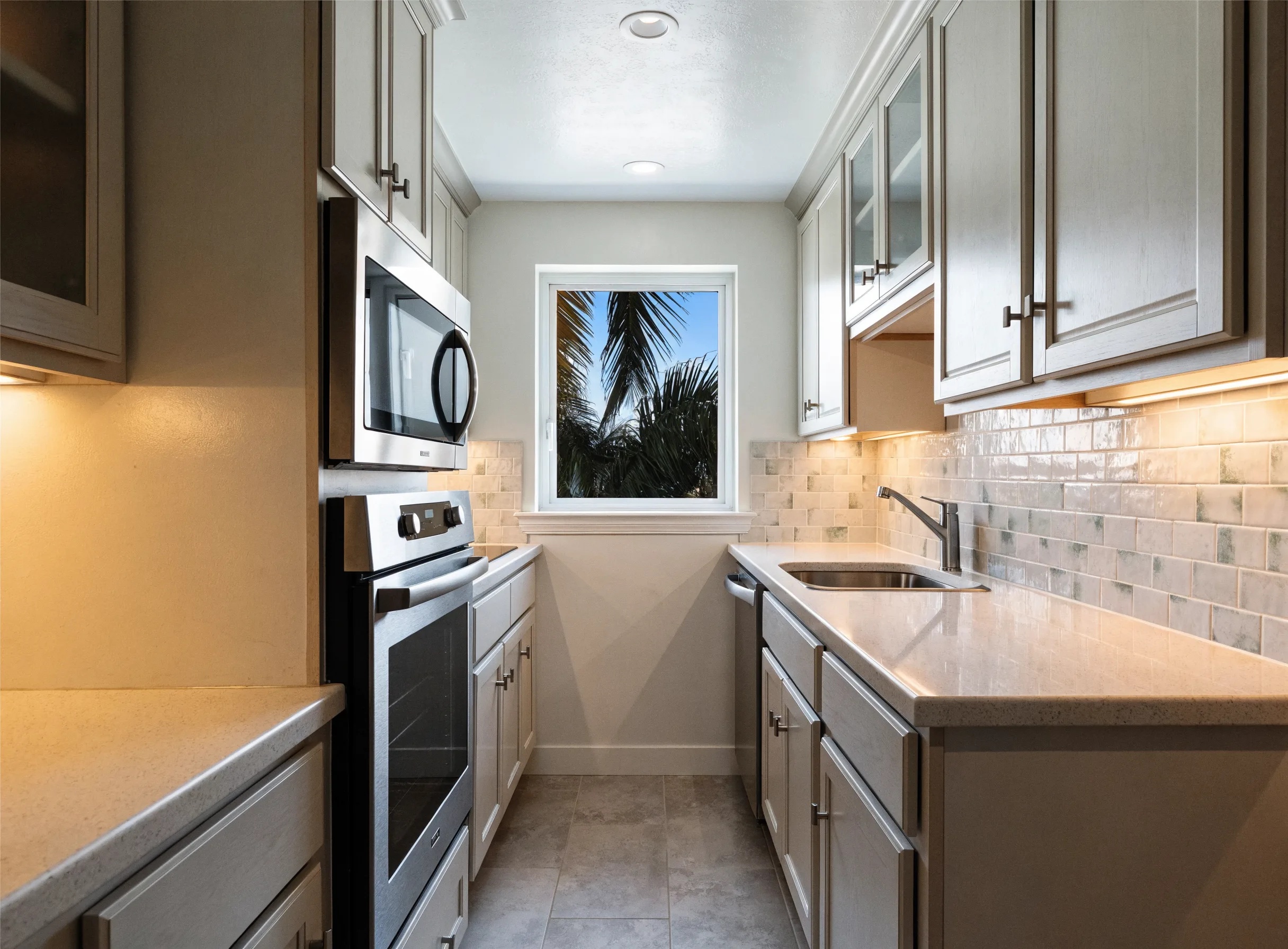 A compact galley kitchen in a Boca Raton condo, under twenty linear feet, with light shaker cabinets